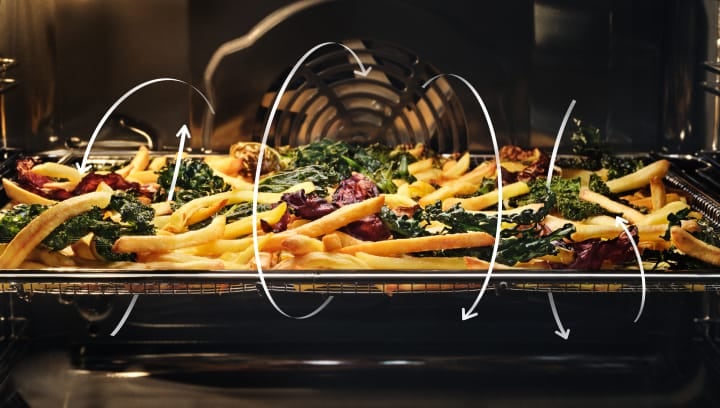 Pommes frites og grønnsaker tilberedes i ovnen.